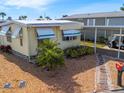 Single-wide manufactured home with carport and landscaped yard at 170 S Saint Thomas Cir, Apollo Beach, FL 33572