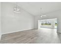 Bright living room with gray vinyl flooring and access to a back porch at 1709 Edgewater Ln, Palmetto, FL 34221