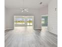 Spacious living area with gray vinyl flooring, and access to a sunroom at 1709 Edgewater Ln, Palmetto, FL 34221
