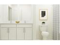 Double vanity bathroom with white cabinets and a shower at 17574 Shirewood Way, Land O Lakes, FL 34638