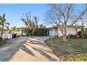Ranch style home with carport and mature landscaping at 1836 Venetian Point Dr, Clearwater, FL 33755