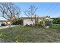 House exterior with mature landscaping at 1836 Venetian Point Dr, Clearwater, FL 33755