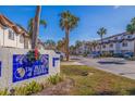 The Palms of Tierra community entrance with lush landscaping and signage at 262 Madeira Cir, Tierra Verde, FL 33715