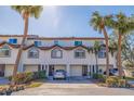 Two story townhome with attached garage and palm trees at 262 Madeira Cir, Tierra Verde, FL 33715