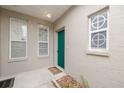 Inviting front entry with teal door and decorative window inserts at 3143 Brooker Creek Way, Palm Harbor, FL 34685