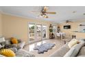 Bright living room with comfy sofas, tiled floor, and access to patio at 4770 Beach Se Dr # B, St Petersburg, FL 33705