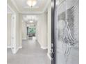 Bright and spacious foyer with tile flooring and view into living area at 5287 Rushmere Ct, Palmetto, FL 34221
