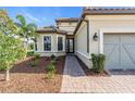Front entrance with walkway, landscaping, and two-car garage at 5287 Rushmere Ct, Palmetto, FL 34221