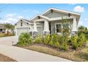 Beautiful two-story home with a three-car garage and well-manicured lawn at 6189 Hidden Branch Dr, Apollo Beach, FL 33572