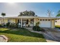 Ranch style home with covered porch and attached garage at 7820 Wallaba Ln, New Port Richey, FL 34653