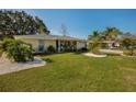 Well-maintained house with a spacious lawn and mature trees at 7820 Wallaba Ln, New Port Richey, FL 34653