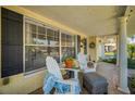 Relaxing front porch with white adirondack chairs at 7820 Wallaba Ln, New Port Richey, FL 34653