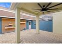 Private patio with ceiling fan, blue wall, and wooden planter at 9911 New Parke Rd, Tampa, FL 33626