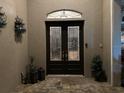 Elegant double door entry with decorative glass and welcoming mat at 10626 Restoration Ter, Bradenton, FL 34212