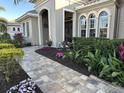 Landscaped walkway leading to the home's grand entrance at 10626 Restoration Ter, Bradenton, FL 34212