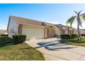 Brick home with two-car garage and palm tree at 1116 Flora Vista St, Trinity, FL 34655