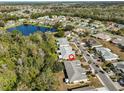 Aerial view showing home's location in a residential community near a lake at 1936 Grand Cypress Ln, Sun City Center, FL 33573