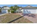 Two-story house with a brick driveway and attached garage at 1936 Grand Cypress Ln, Sun City Center, FL 33573