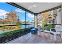 Relaxing screened porch overlooking a lake, two chairs at 2400 Feather Sound Dr # 1215, Clearwater, FL 33762
