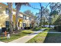 Landscaped backyard with a view of neighboring homes and trees at 37650 Aaralyn Rd, Zephyrhills, FL 33542