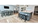Bright dining area with light wood floors and modern decor adjacent to kitchen at 3909 W Eden Roc Cir, Tampa, FL 33634
