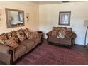 Living room features brown sofas, decorative pillows, and a maroon rug at 529 Carriage Hills Dr, Temple Terrace, FL 33617