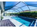 Inviting screened-in pool area with lounge chairs and a wooden deck at 8610 Quinn Ct, North Port, FL 34287