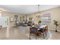 Bright dining area with a chandelier and seating for six at 10829 Breaking Rocks Dr, Tampa, FL 33647