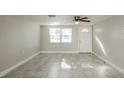 Spacious living area with tile floors and an exterior door at 1172 Fernwood Dr, Holiday, FL 34690