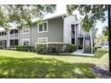 Gray condo building with exterior stairs and landscaping at 11847 Skylake Pl # D, Tampa, FL 33617