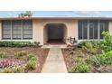 Ground level condo entrance with walkway and landscaping at 13215 Slash Pine Dr # H, Hudson, FL 34669