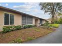 Tan building exterior with landscaping and a paved pathway at 13215 Slash Pine Dr # H, Hudson, FL 34669