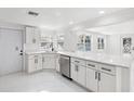Modern kitchen with white cabinets and stainless steel appliances at 177 Dowling Ne Ave, Port Charlotte, FL 33952