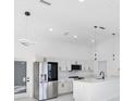 Modern kitchen featuring white shaker cabinets, stainless steel appliances, and a large island at 18434 Goodman Cir, Port Charlotte, FL 33948