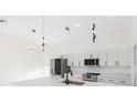 Modern kitchen with white cabinets, stainless steel appliances, and a quartz island at 18434 Goodman Cir, Port Charlotte, FL 33948