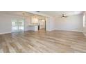 Bright and spacious living room with wood-look tile flooring and access to the kitchen at 1905 Bryan Rd, Brandon, FL 33511