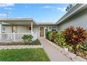Welcoming walkway to the front door, surrounded by lush landscaping at 1985 Byram Dr, Clearwater, FL 33755