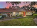 Condo exterior at sunset, featuring a red tile roof at 2058 Villa Ter, Clearwater, FL 33763