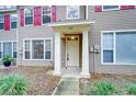 Two-story home's front entrance with white door and columns at 2131 Golden Oak Ln, Valrico, FL 33594
