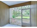 Screened-in porch overlooking a grassy backyard at 2131 Golden Oak Ln, Valrico, FL 33594