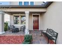 Front porch with seating and a decorative entrance at 30868 Kelmin Ter, Wesley Chapel, FL 33543