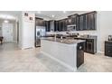 Spacious kitchen with dark cabinets, granite counters, and stainless steel appliances at 30868 Kelmin Ter, Wesley Chapel, FL 33543