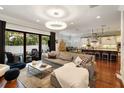 Open concept living room with kitchen views, hardwood floors, and comfortable furniture at 3608 W Horatio St, Tampa, FL 33609