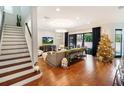 Spacious living room with hardwood floors, a large TV, and a Christmas tree at 3608 W Horatio St, Tampa, FL 33609