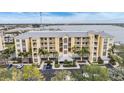 Aerial view of waterfront condo building with parking and boat slips at 425 150Th Ave # 2401, Madeira Beach, FL 33708