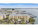 Aerial view of a waterfront condo building with boat slips at 425 150Th Ave # 2401, Madeira Beach, FL 33708