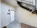 Condo entry with white door and black metal stairs at 4507 S Oak Dr # P71, Tampa, FL 33611