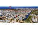 Stunning aerial shot of the waterfront community, showcasing canals, boat docks, and proximity to open water at 5606 Seagrass Pl, Apollo Beach, FL 33572