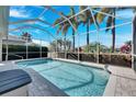 Sparkling screened-in pool area, an ideal oasis for relaxation and entertainment in a private outdoor space at 5606 Seagrass Pl, Apollo Beach, FL 33572