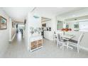 Bright dining area with white table and chairs, view of kitchen at 5901 Bahia Del Mar Cir # 321, St Petersburg, FL 33715